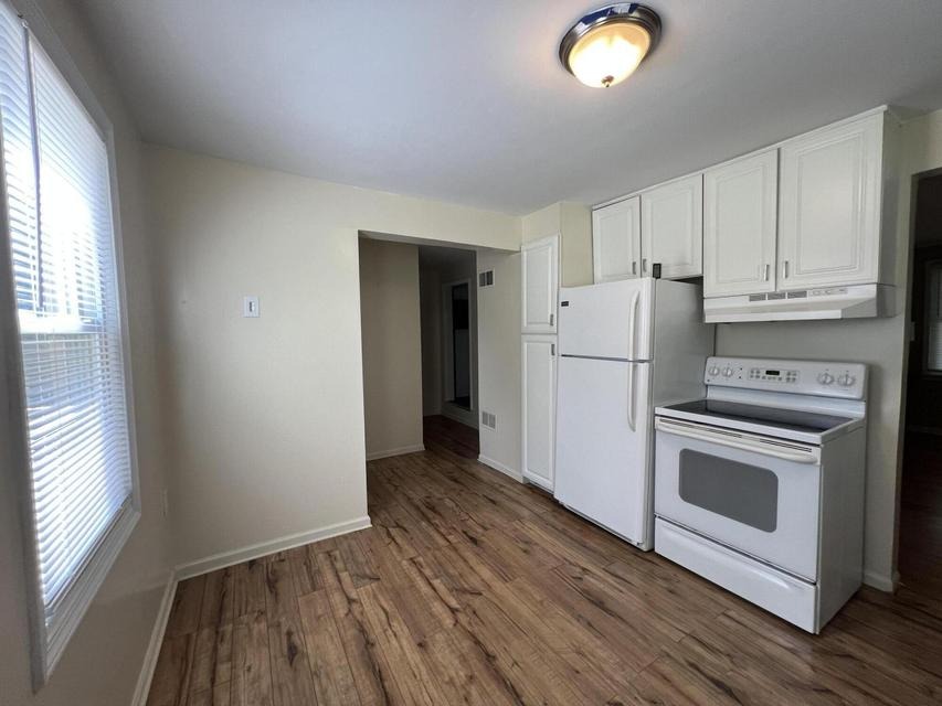 Kitchen with range and refrigerator