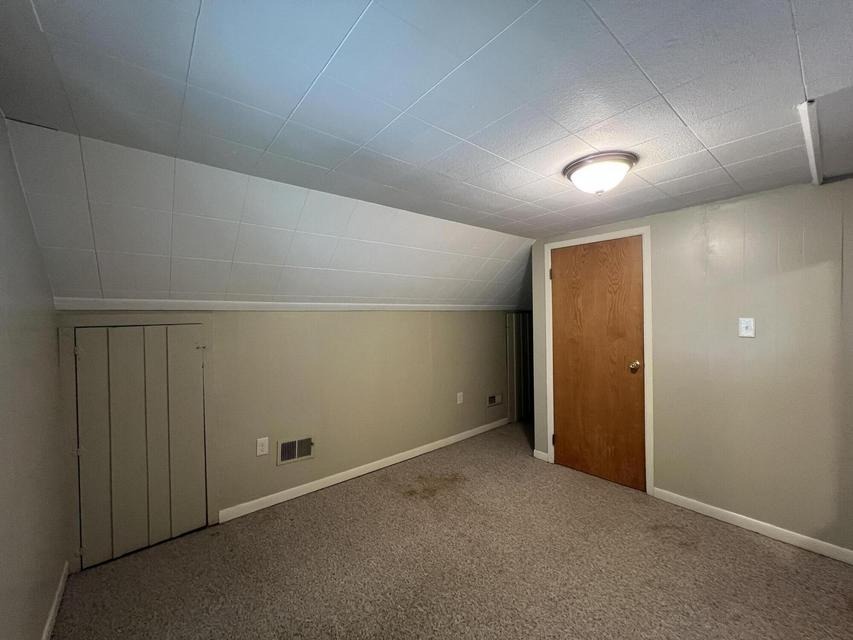 Upper bedroom with wood door